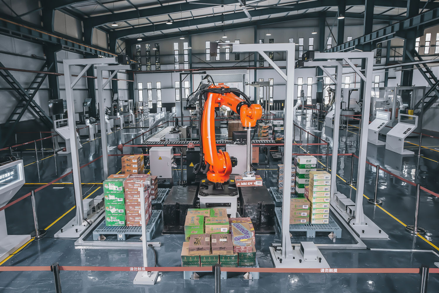 orange robot in factory with boxes